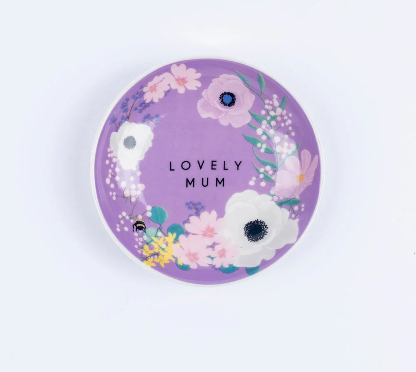 A bone china trinket dish with a purple background, featuring white, pink, and blue flowers, and the text 'LOVELY MUM' in the center.