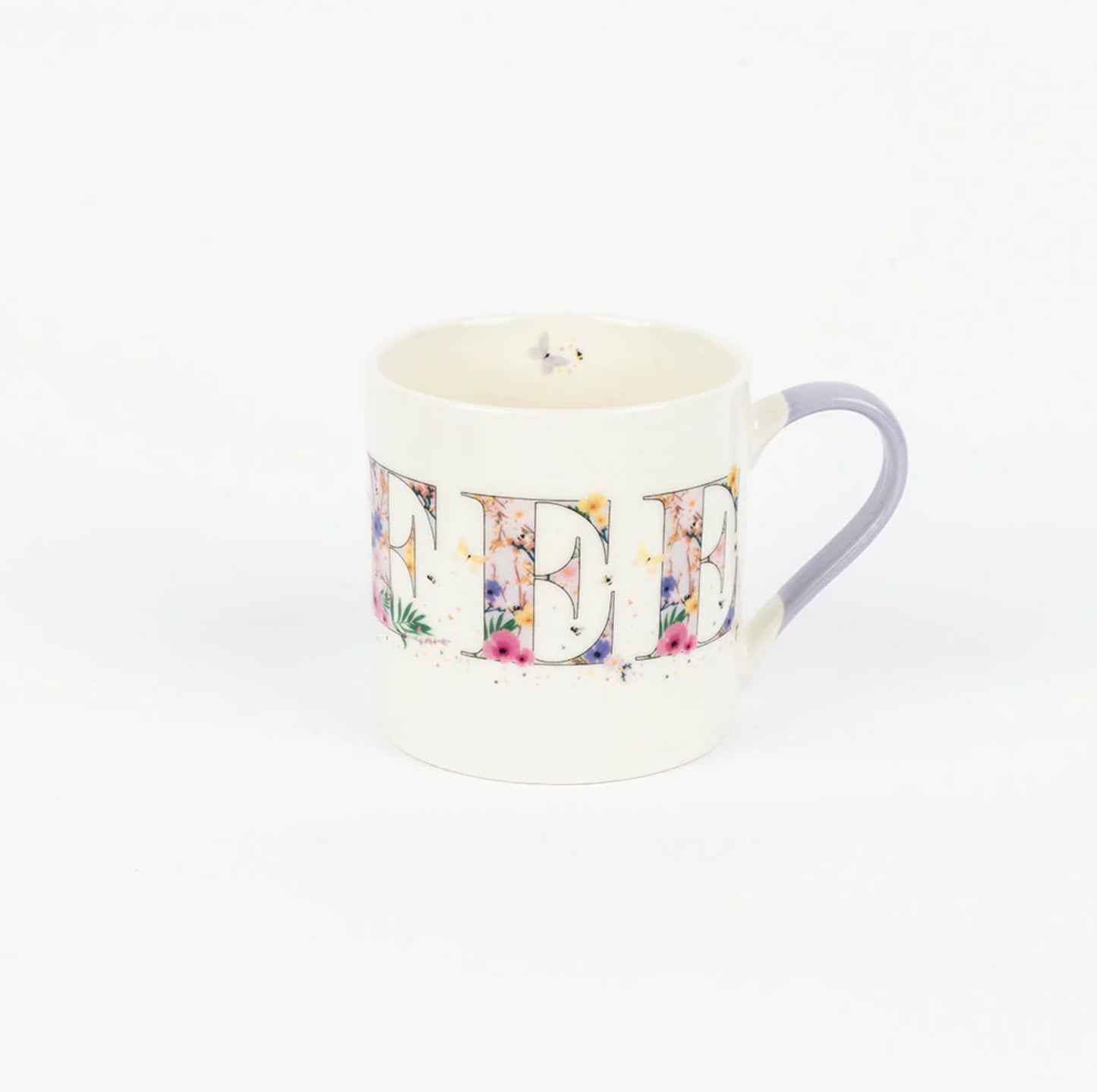 A white bone china mug with a multicolored floral pattern and a blue handle, displayed against a plain background.