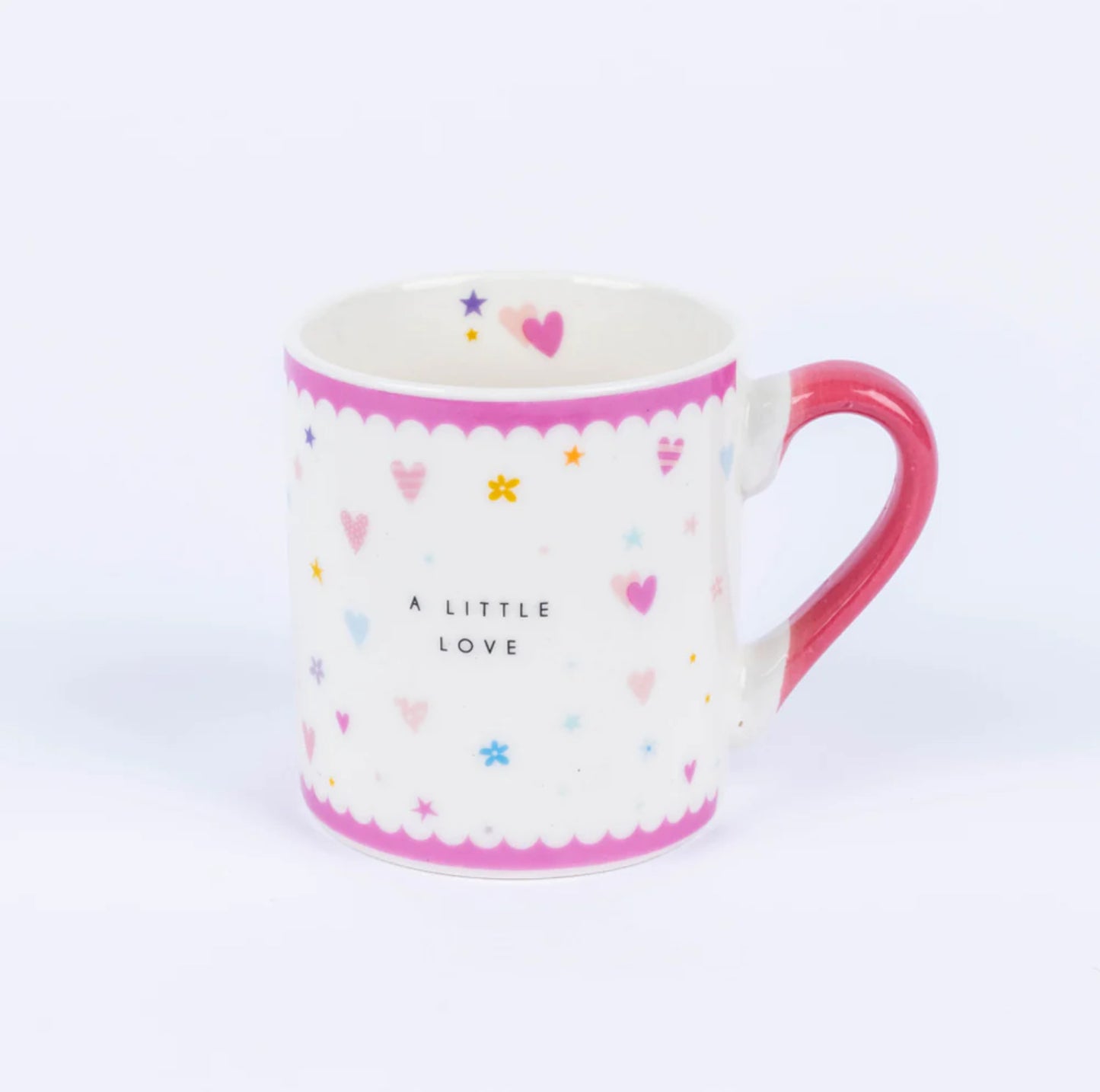 A white china mug with pink accents and multicolored design, featuring the text 'A LITTLE LOVE' and various shapes like hearts and stars.