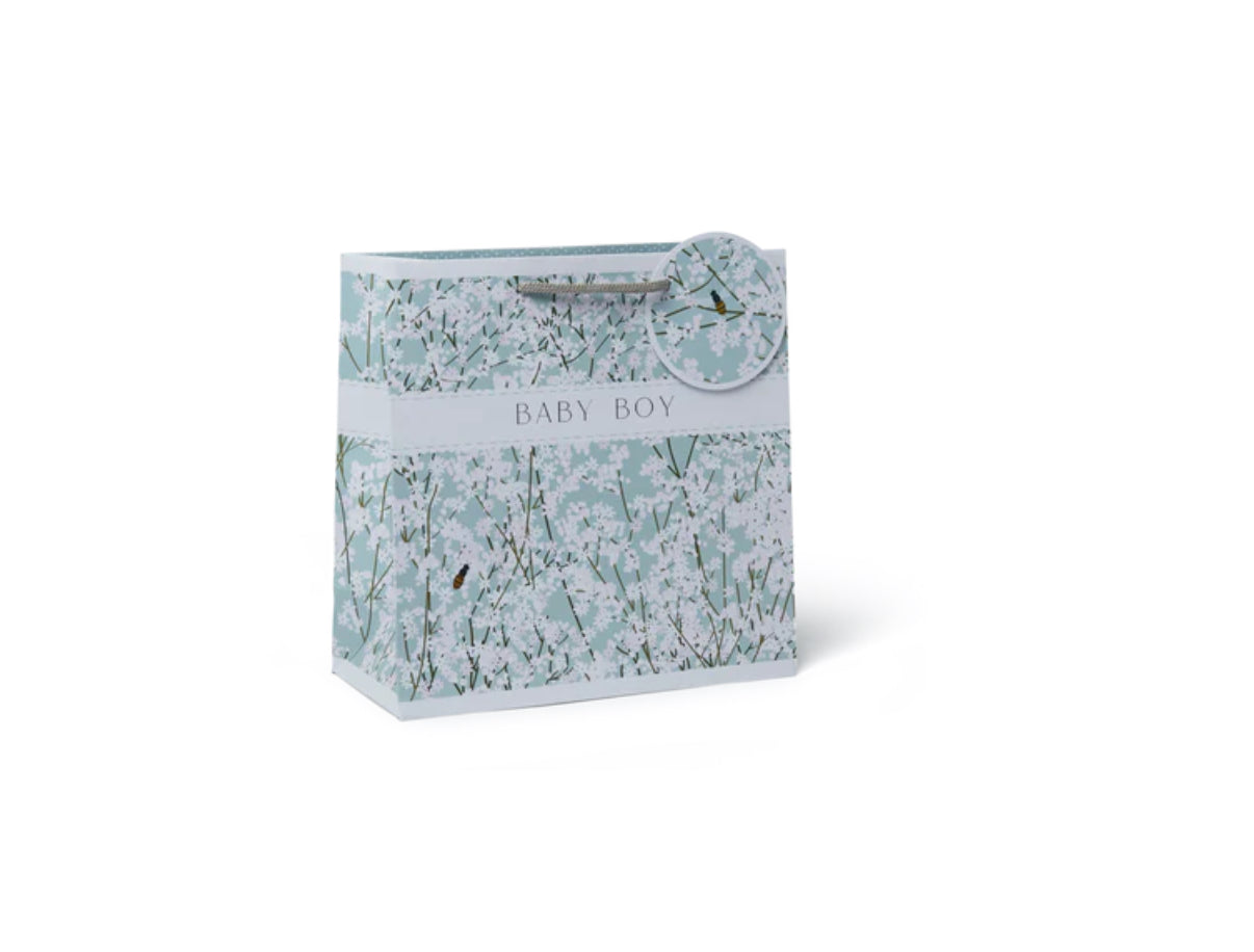 A medium-sized gift bag with a floral pattern in shades of blue and white, labeled 'Belly Button Designs' for a baby boy.