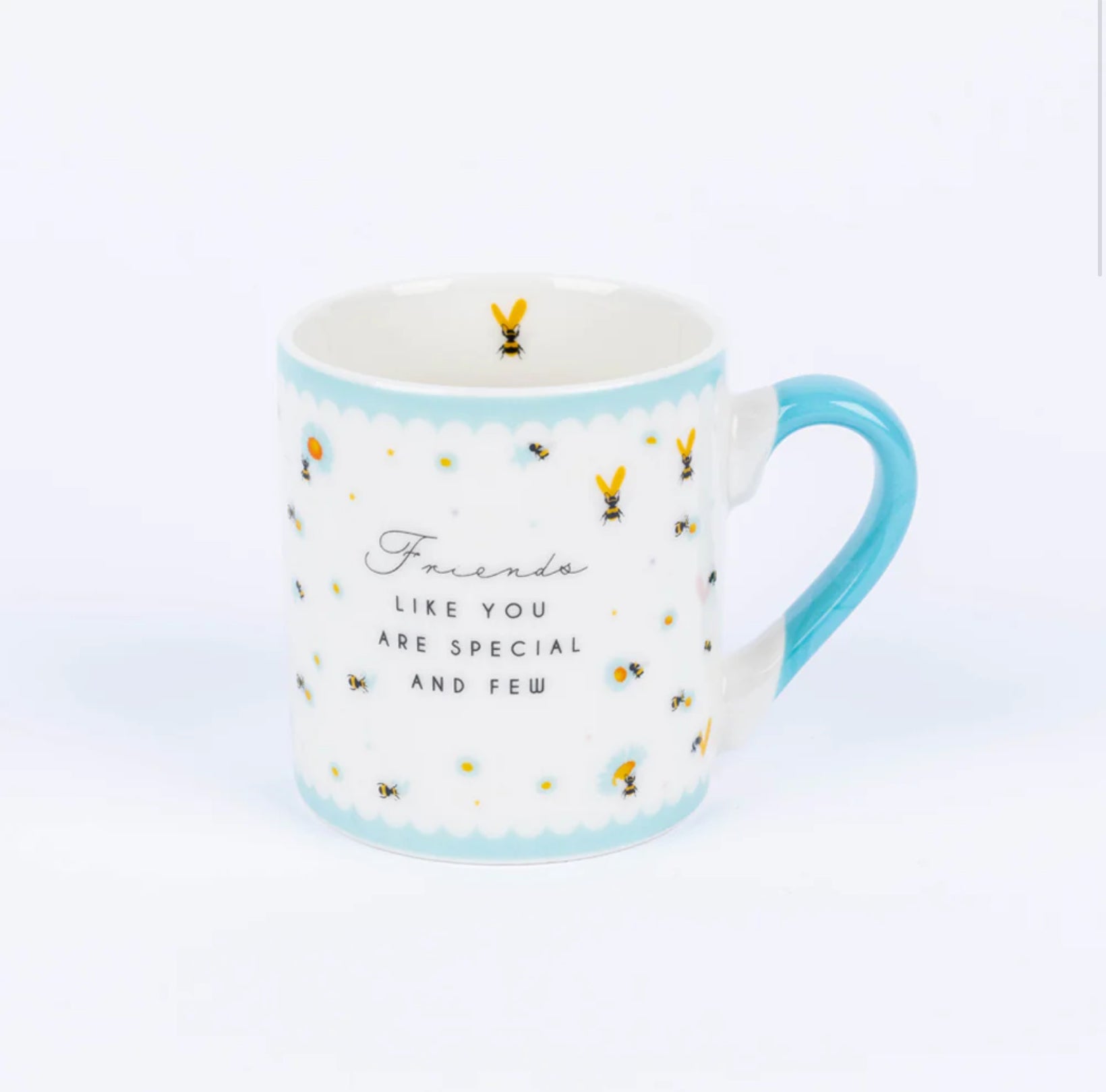 A small white and blue china mug with a 'Friends like you' inscription and bee designs on it.