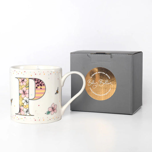 A white china mug with a colorful floral and insect design, featuring the monogram initial 'P', and a grey presentation box with 'Belly Button Designs' branded on it.