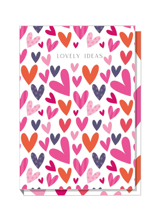A5 hardback notebook with a colorful cover featuring a pattern of big hearts in pink, orange, and purple shades.