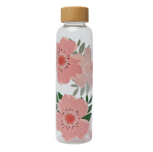 A clear glass water bottle with pink rose floral designs and a bamboo cap.