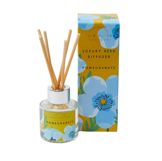 A luxury reed diffuser with blue poppy design, including a glass bottle with a label, natural fibre reeds, and a packaging box with a floral design.