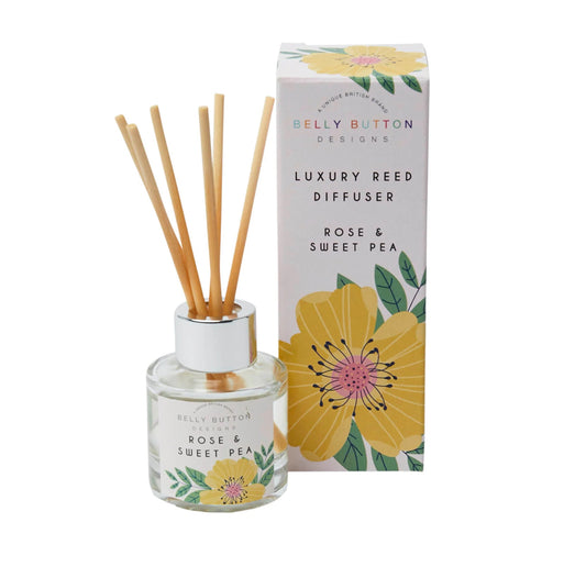 Belly Button luxury reed diffuser with the scent rose and sweet pea in pink and floral packaging.
