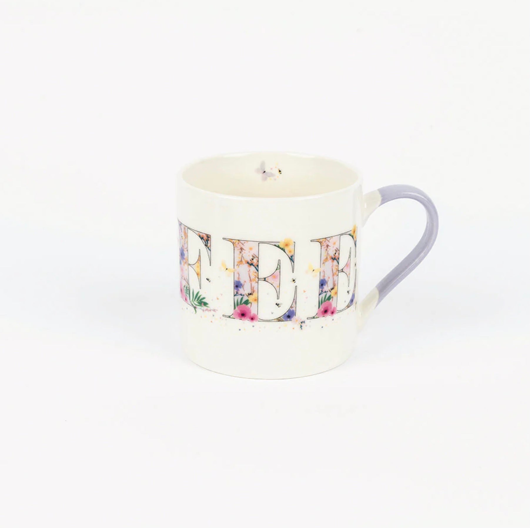 A white bone china mug with a multicolored floral pattern and a blue handle, displayed against a plain background.