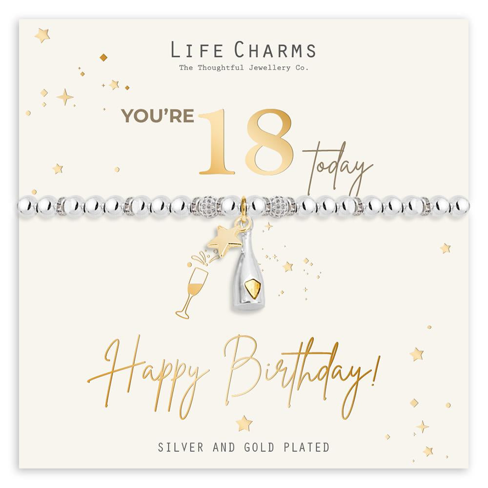 A silver and gold plated bracelet with a birthday card featuring a gold foil background, stars, and a champagne bottle. The card reads 'You're 18 today' and 'Happy Birthday!'.