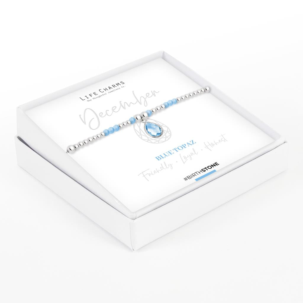 Life Charms December birthstone bracelet with silver-plated beads and blue topaz charm, presented in a gift box.