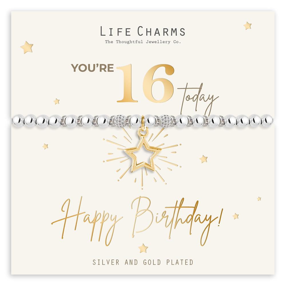 A silver and gold plated bracelet with a gold star and champagne bottle charm, presented on a gold foiled card with 'Life Charms' branding and 'You're 16 Today' text.