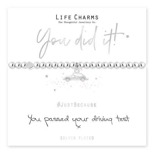 A silver-plated pug charm bracelet with 'You did it' text and a car icon, presented on a card with '#JustBecause' and 'SILVER PLATED' hashtags.
