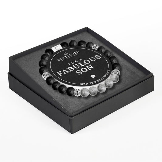 An elastic bracelet with black and white beads, featuring an elegant tear drop pendant, presented in a square black box with a birthday message for a son.