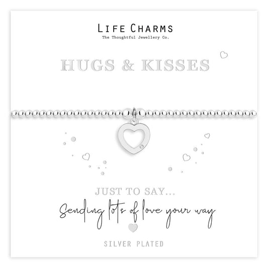 A silver-plated beaded bracelet with a heart charm, presented on a card with the message 'HUGS & KISSES' and 'SENDING LOVE YOUR WAY'. The bracelet is in a white gift box, part of a 'Life Charms' collection.