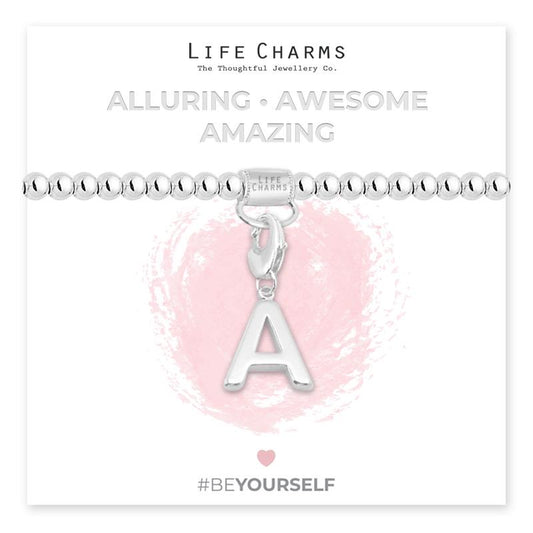 Initial charm bracelet with the letter A, presented on a silver foiled card with the text 'ALLURING • AWESOME • AMAZING' and the brand name 'LIFE CHARMS'. The bracelet is silver, and the card has a pink background with a heart shape.