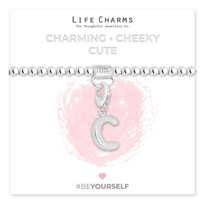 Initial charm bracelet with the letter C, presented on a silver foiled card with the text 'CHARMING • CHEEKY • CUTE' and the brand name 'LIFE CHARMS'. The bracelet is silver, and the card has a pink background with a heart shape.