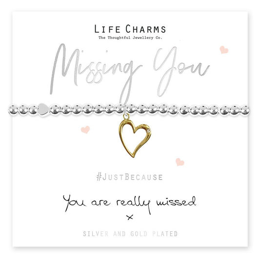 A gold-plated open heart charm bracelet with silver bead accents, presented on a card that reads 'Missing You' and 'You are really missed'. The bracelet is accompanied by a luxury gift box.
