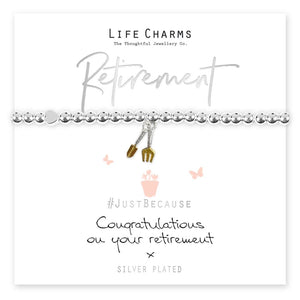 A silver-plated beaded bracelet with a gold garden spade charm, presented on a card that reads 'LIFE CHARMS Retirement' and 'Just Because Congratulations on your retirement'.