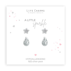 A set of silver-plated earrings featuring a star and drop design, packaged in a box with 'Life Charms' branding and a Christmas sleeve.
