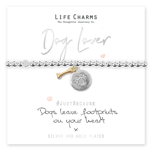 A silver-plated charm bracelet with a dog and paw print design, presented on a card that reads 'Dog Lover' and includes a quote about dogs leaving footprints on your heart.