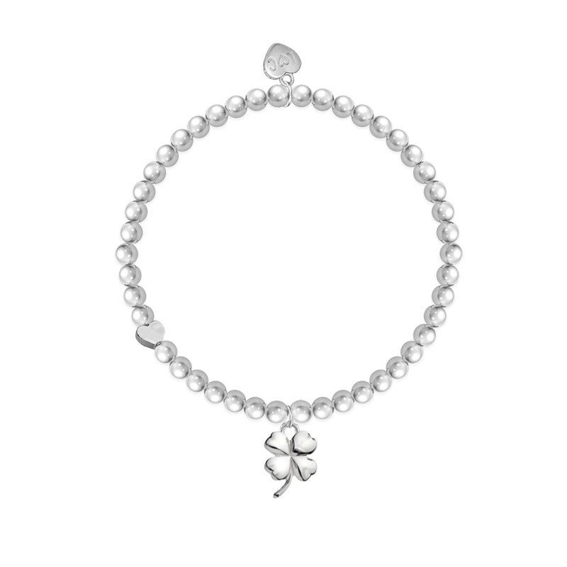 A silver-plated bracelet featuring a four-leaf clover charm on a beaded stretch band.