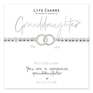 A silver-plated bracelet with a crystal encrusted circle charm, presented on a card that reads 'Granddaughter' and 'Just Because You are a gorgeous granddaughter'. The bracelet is shown with a clear crystal charm and bead details.
