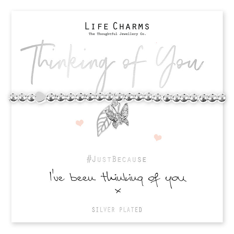 A silver beaded stretch bracelet with a star charm, presented on a card that reads 'Thinking of You' and includes a message. The bracelet is to be given as a gift and comes in a luxury gift box.